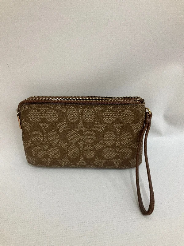 Coach Dempsey bags with a contrast - colored interior for visual interestWristlet Designer By Coach  Size: Medium