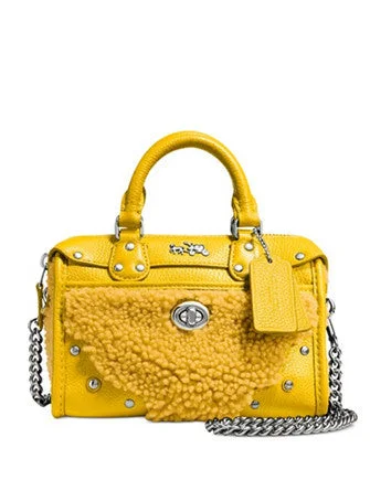 Coach handbags with a perforated leather detail for a breathable and unique designCoach Rhyder Satchel 18 In Shearling and Leather