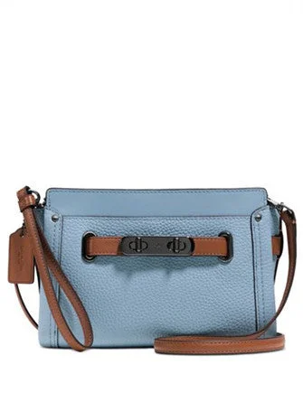 Coach Dempsey bags with a contrast - colored interior for visual interestCoach Swagger Wristlet in Colorblock Pebble Leather