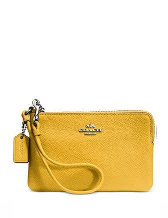 Ladies Coach Borough bags in a pastel shade for a soft and delicate appearanceCoach Embossed Small L-Zip Wristlet in Leather