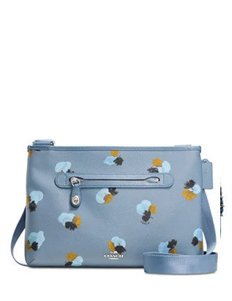 Coach tote bags with a snap - button closure and a decorative charm for styleCoach Taylor Crossbody in Floral Print Coated Canvas